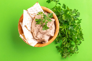 Fresh homemade chicken liver pate with matzo and parsley