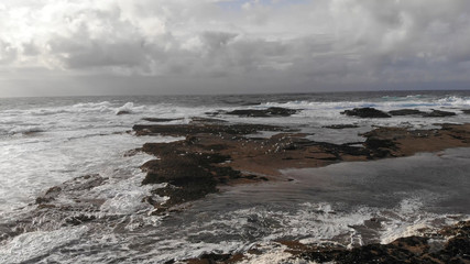 Low Aerial view over wild ocean water in the evening