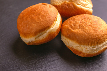 Tasty sweet donuts with on black slate background