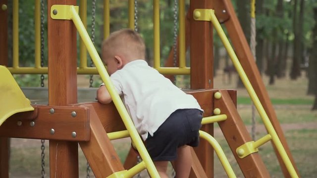 Child climbs the children's slide