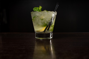 Cuban mojito coctail in a frozen glass with lime and mint leaves