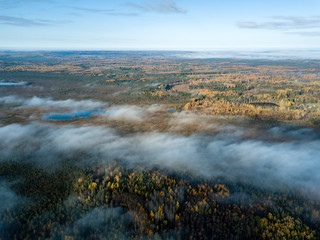 drone image. aerial view of rural area with fields and forests covered in mist