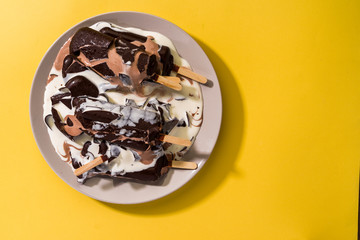 melted ice cream in a plate on a yellow background