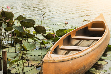 OLD BOAT WITH LOTUS (WATER LILY), SOUTHEAST ASIA, THAILAND.
