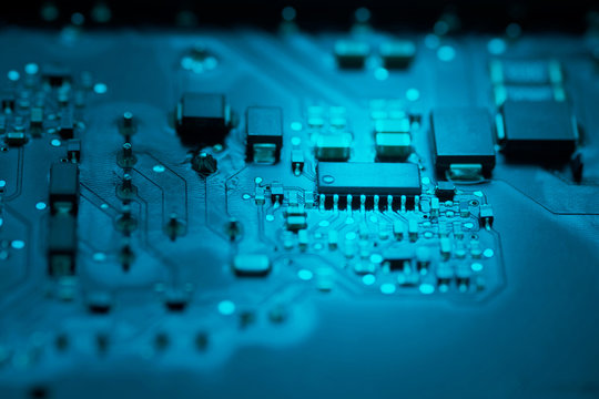 CLOSE UP COMPUTER CIRCUIT BOARD IN BLUE TONE