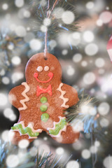 GINGERBREAD MAN ON CHRISTMAS TREE WITH BOKEH OF SNOW (FOR BACKGROUND)