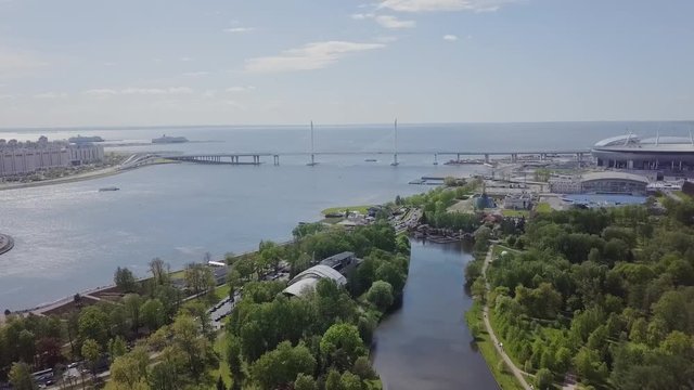 Beautiful aerial view on a bridge in St Petersburg with a FIFA stadium and water, cruise ships and lake in a park