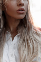 Female beautiful natural lips closeup. Girl outdoors on a autumn day at sunset