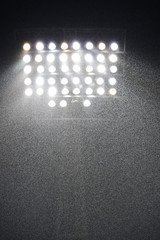 Raining in the stadium and spotlight.