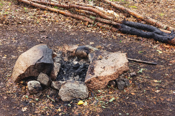 Campfire place among stones in the forest