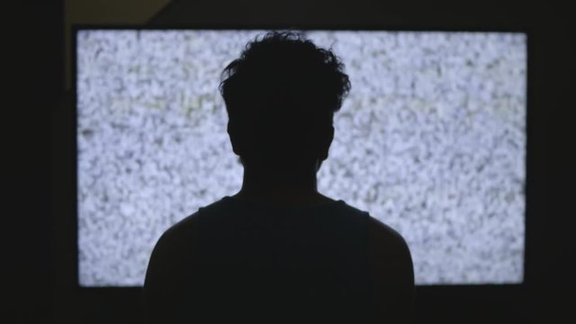 Man staring at television static (Push)