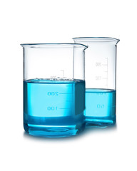 Beakers with liquid on table against white background. Laboratory analysis