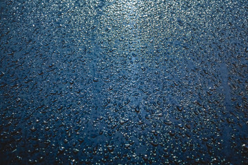 Rain drops on the surface of the car, abstract background