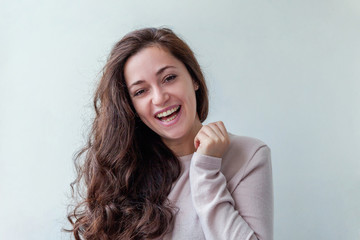 Naklejka premium Happy girl smiling. Beauty portrait young happy positive laughing brunette woman on white background isolated. European woman. Positive human emotion facial expression body language