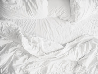 Top view of unmade bedding sheets and pillow ,Unmade messy bed after comfortable sleep concept - obrazy, fototapety, plakaty