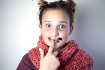 Young girl with messy chocolate face.