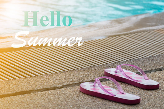 " Hello Summer " WITH PINK FLIP FLOP BY THE EDGE OF SWIMMING POOL (The Image Has Shallow Depth Of Field)
