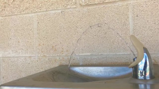 Waco Independent School District Stadium In Texas In America, Steady Handheld Medium Shot Of Water Fountain In Slow Motion