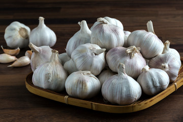 Garlic bulb and cloves in bamboo tray weave