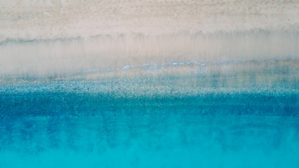 Fototapeta na wymiar Top view of beautiful beach. Aerial drone shot of turquoise sea water at the beach