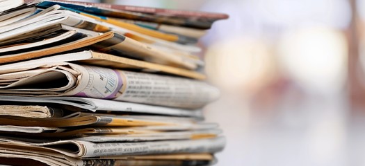 Pile of printed newspapers on background