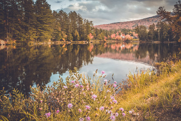 Long Lake, Adirondacks, NY, in the fall surrounded by brilliant colorful foliage