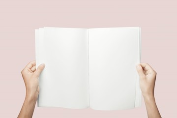 Obraz premium Hands holding blank book isolated on background