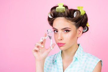 vintage housewife woman curl eyelashes with tool. Pinup girl. beauty salon and hairdresser. retro woman with fashion makeup and hair. happy girl grooming in morning, copy space. Stylish and confident
