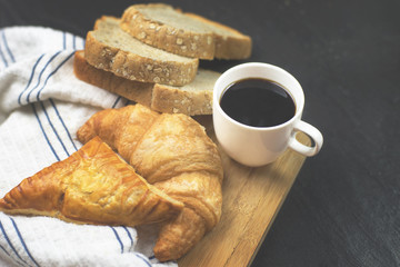 black coffee for healthy  and bread with Croissant , Pie in the wood in the morning.