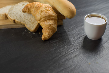coffee cup and bread with Croissant , Pie in the wood in the morning.
