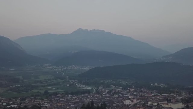 Aerial panoramic view of Levico Terme, Italy, during sunrise with drone panning left to right