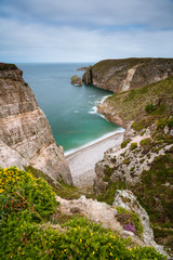 Spectacular cliffs in Cap Frehel, Pointe du Jas, small beach and island Amas du Cap on a cloudy day...