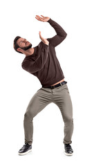 A bearded man in casual garb stands protecting himself with outstretched hands from something...