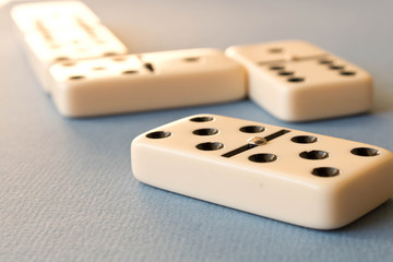 Playing dominoes on a blue background . Domino concept