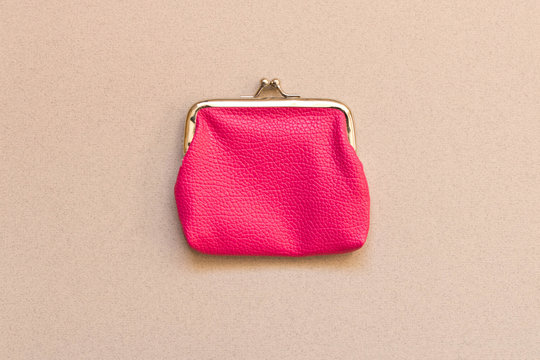 Pink wallet on grey background . Close up. Top view