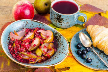 Hot tea, croissant, autumn maple leaves
