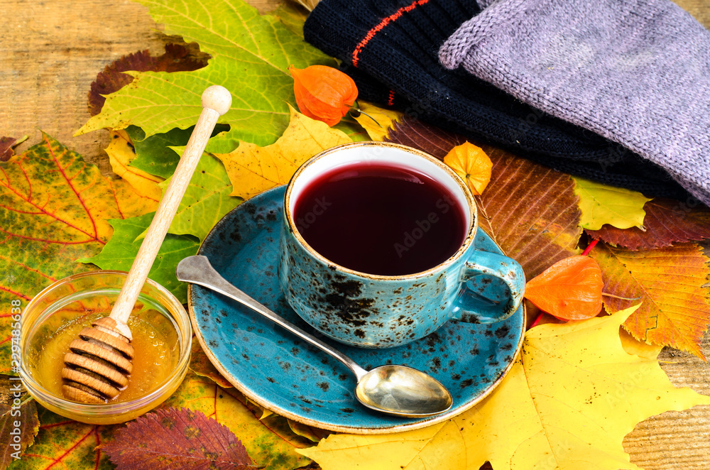 Canvas Prints Сup of hot red tea from karkade, beautiful autumn leaves on table