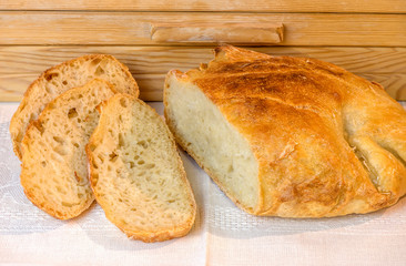 loaf of sliced white artisan bread, on the table near the breadbasket