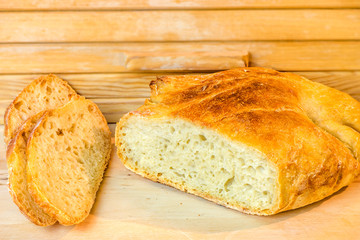 loaf of sliced white artisan bread, on the table near the breadbasket