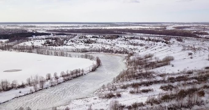 Drone view of outskirts of Gomel Belarus and Ice Fisherman on River