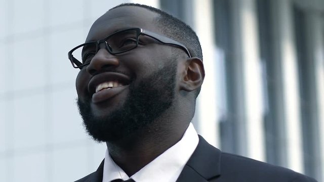 African american business man smiling, looking into bright future, success