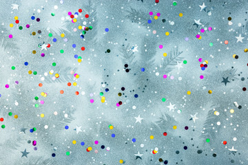 winter background with christmas tree branches imprints and colorful glitter confetti