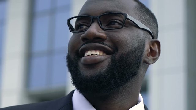 Successful african american man rejoicing promotion, business goals, motivation