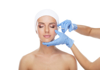 Doctor injecting in a beautiful face of a young woman. Plastic surgery concept.