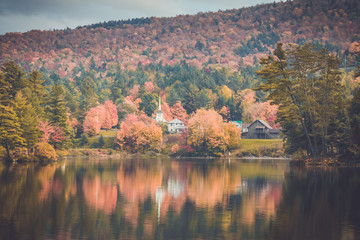 Long Lake, Adirondacks, NY, in the fall surrounded by brilliant colorful foliage