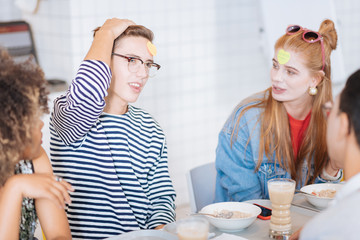 Try to guess. Kind girl turning head while looking at her group mate