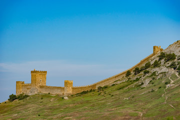 Genoese fortress on top of the mountain against the blue sky.