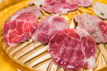 Raw meat sliced grill on hot pan, Korean barbecue or Yakiniku in japanese.