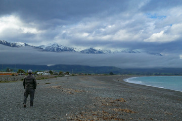 Kaikoura Beach with low cloud and mountains