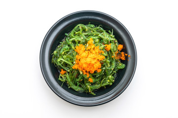 seaweed salad with shrimp eggs isolated on white background